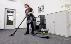 A-1 Carpet Cleaning technician HEPA vacuuming pet hair and dander in an Ames home