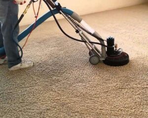 Technician deep cleaning carpet in Ames Iowa home with Rotovac equipment